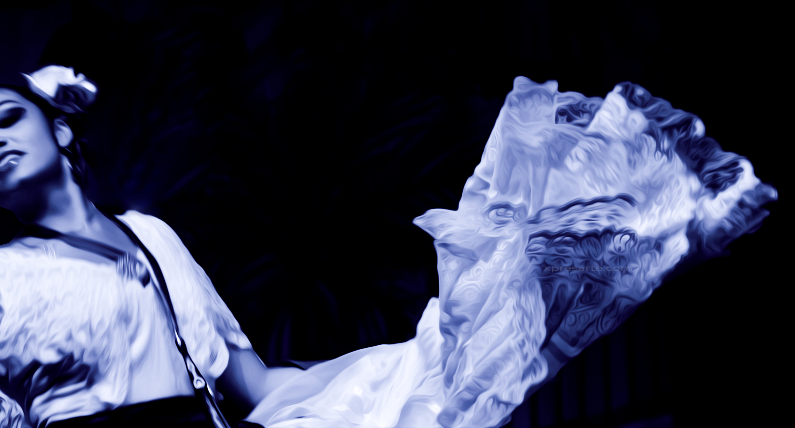 A female dancer dressed in traditional garb from the state of Veracruz in the middle of an impassioned dance